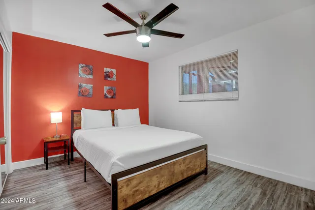 a bedroom with a bed and a table