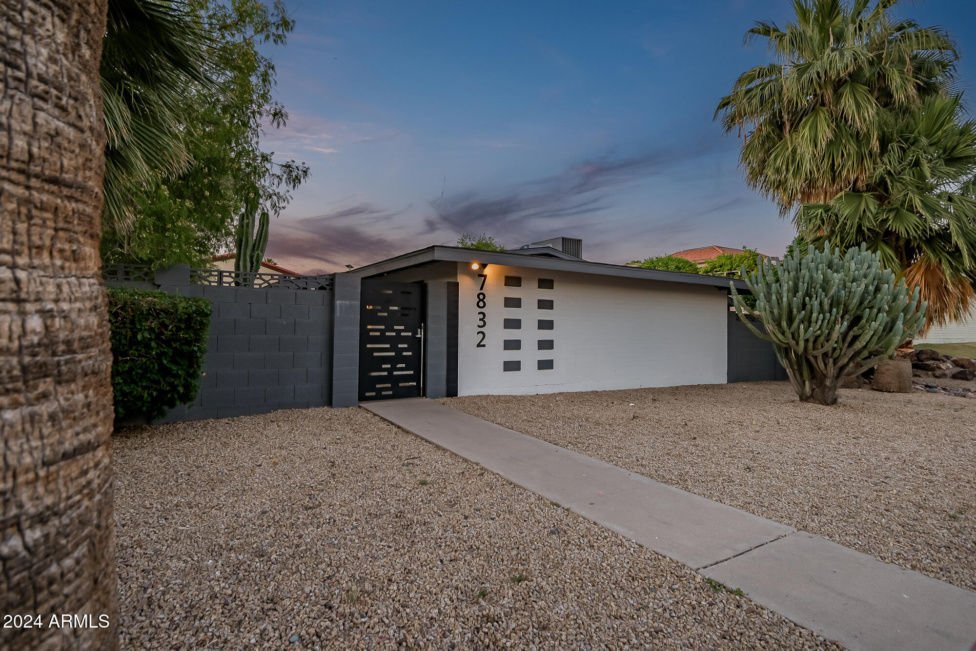 7832 East Heatherbrae Avenue, Unit C Scottsdale, AZ 85251 - Photo 43 of 48 a front view of a house with a yard and garage