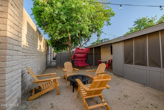 a view of backyard with outdoor seating and plants