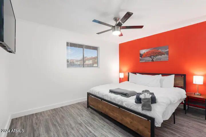 7832 East Heatherbrae Avenue, Unit C Scottsdale, AZ 85251 - Photo 8 of 48 a bedroom with a bed and a painting on the wall