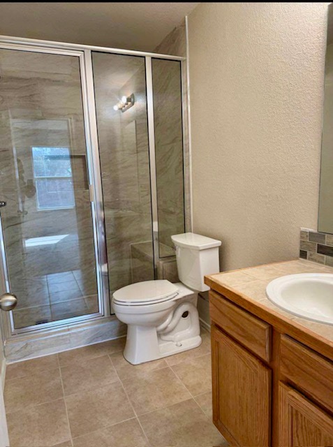400 Blue Shale Drive Jarrell, TX 76537 - Photo 6 of 22 a bathroom with a sink a toilet and shower