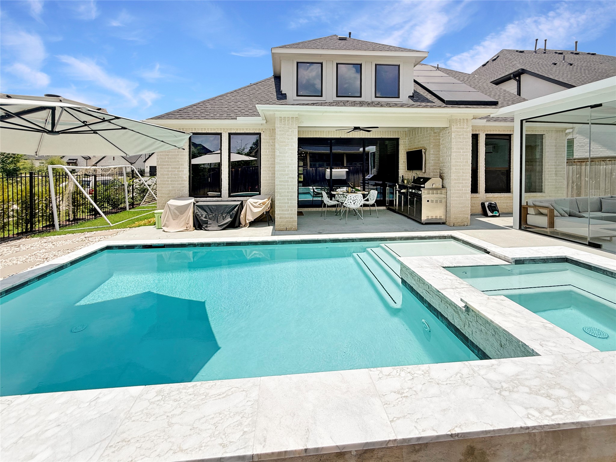 26918 Swanborough Road Spring, TX 77389 - Photo 39 of 50 Enjoy family and friends in this backyard paradise! A resort-style pool and raised spa anchor the outdoor space, framed by multiple covered patios for year-round entertaining.
