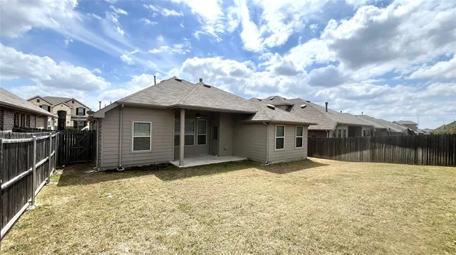 a view of a house with wooden fence