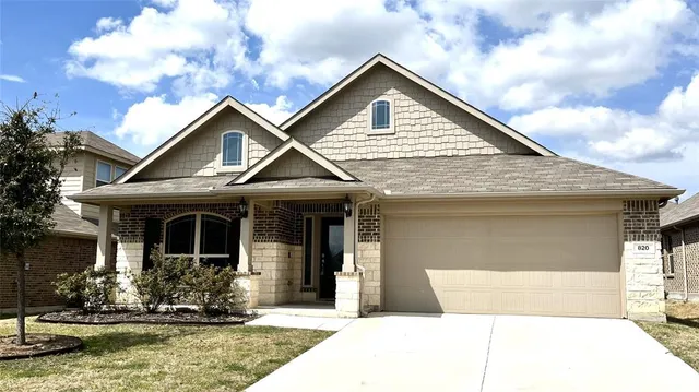 a front view of a house with garage