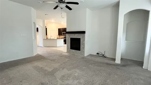 a kitchen with granite countertop a refrigerator and a stove top oven