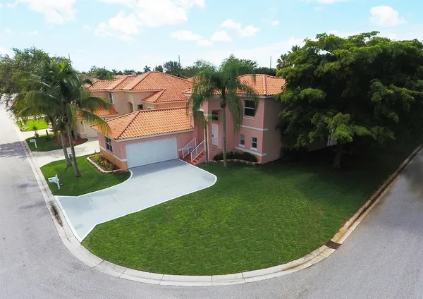 a house with palm tree in front of it
