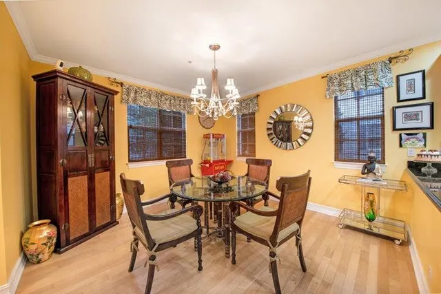 a view of a dining room with furniture and a chandelier