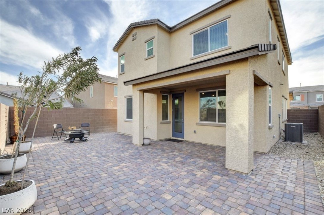 6920 Fossil Rim Street North Las Vegas, NV 89084 - Photo 9 of 9 A spacious backyard features a paver patio, ideal for outdoor gatherings.