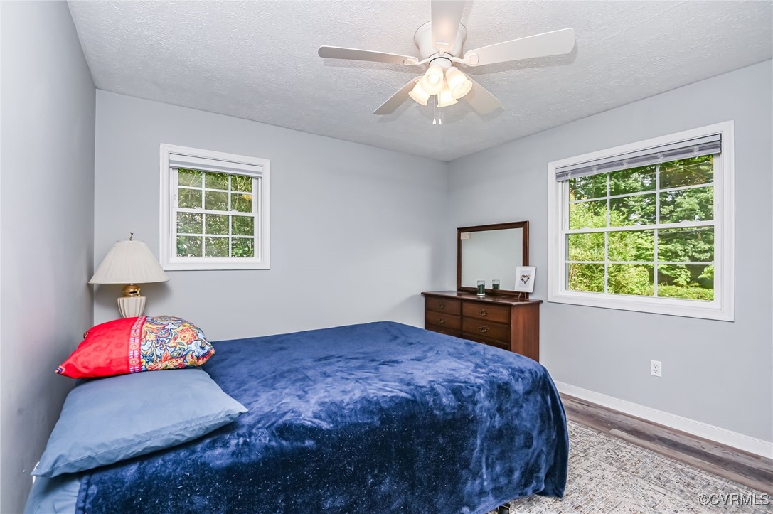 184 Fox Road Gum Spring, VA 23065 - Photo 15 of 27 a bedroom with a bed and a chandelier