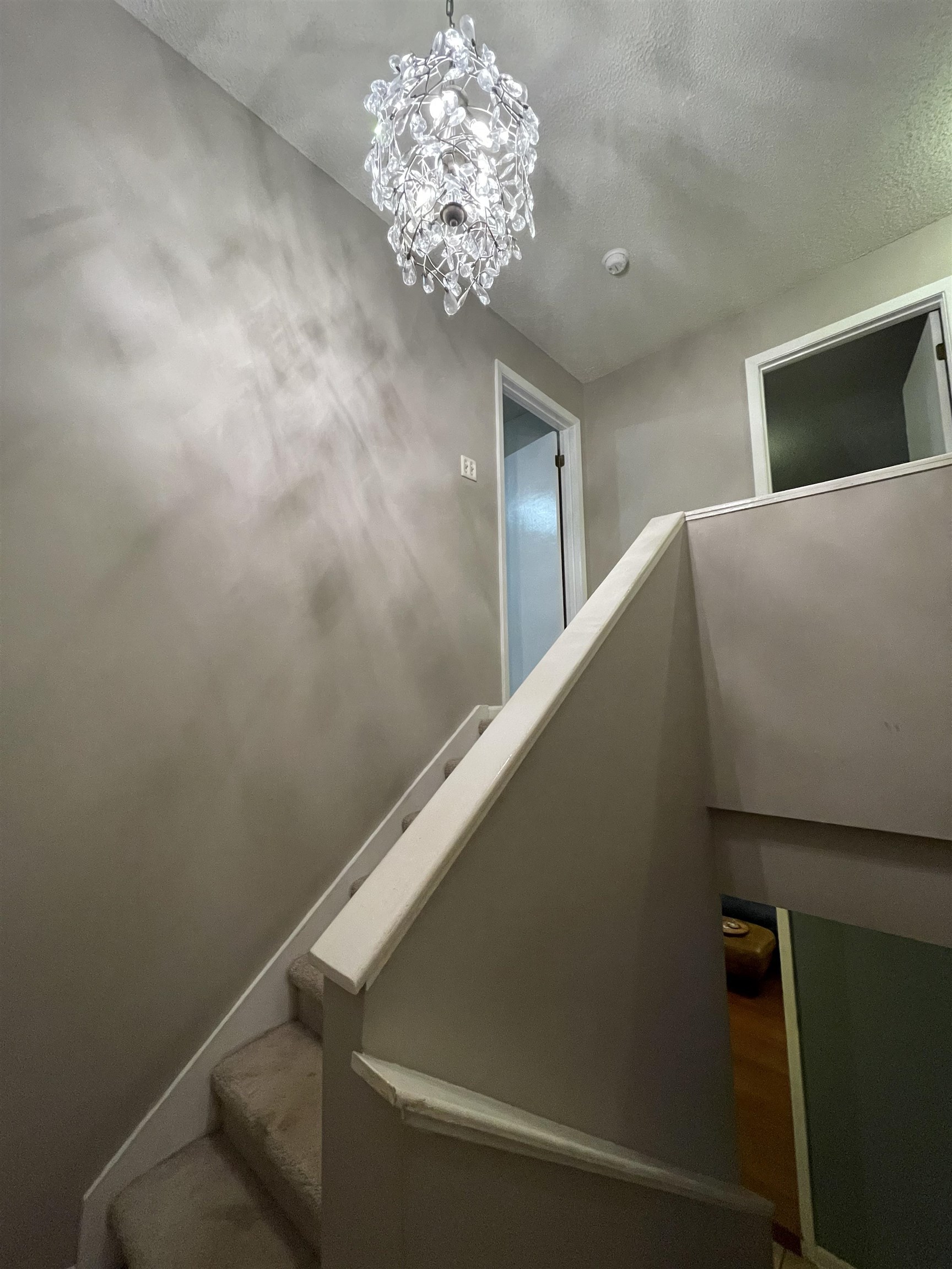 8469 Rothchild Road, Unit 33 Germantown, TN 38139 - Photo 17 of 25 Stairway with a textured ceiling and a notable chandelier
