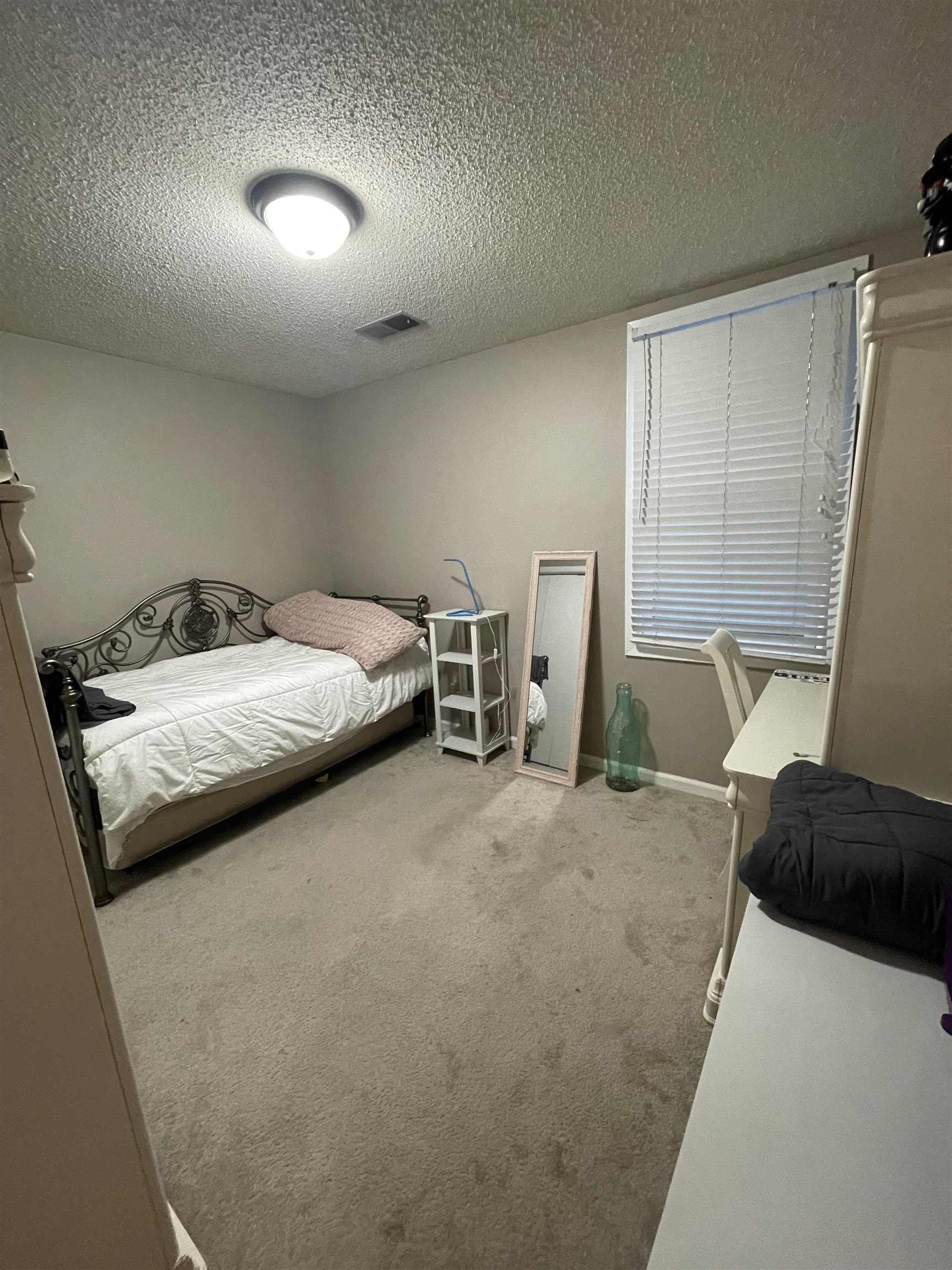 8469 Rothchild Road, Unit 33 Germantown, TN 38139 - Photo 21 of 25 Carpeted bedroom with a textured ceiling