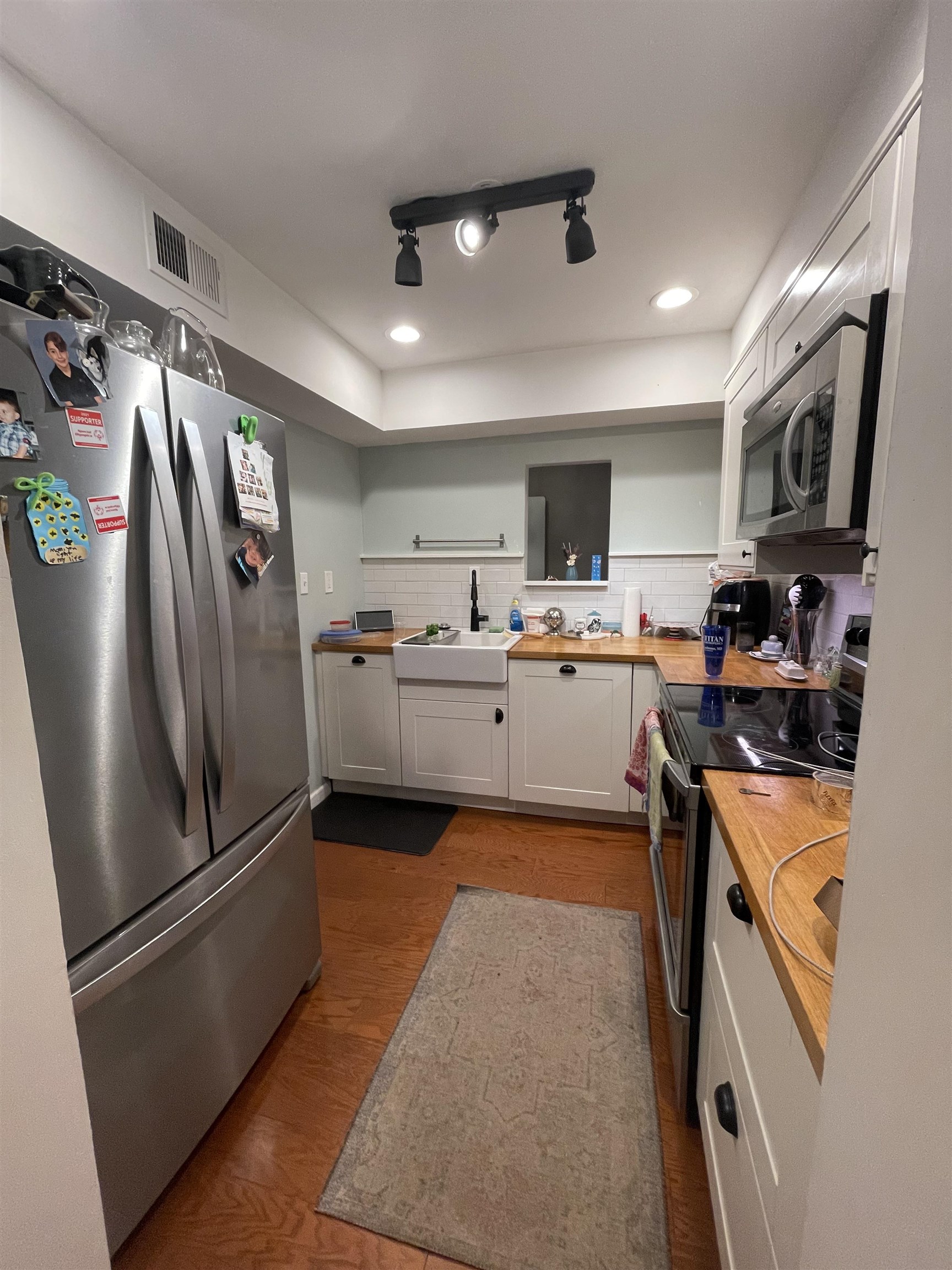 8469 Rothchild Road, Unit 33 Germantown, TN 38139 - Photo 7 of 25 Kitchen with white cabinetry, sink, butcher block countertops, light hardwood / wood-style floors, and appliances with stainless steel finishes