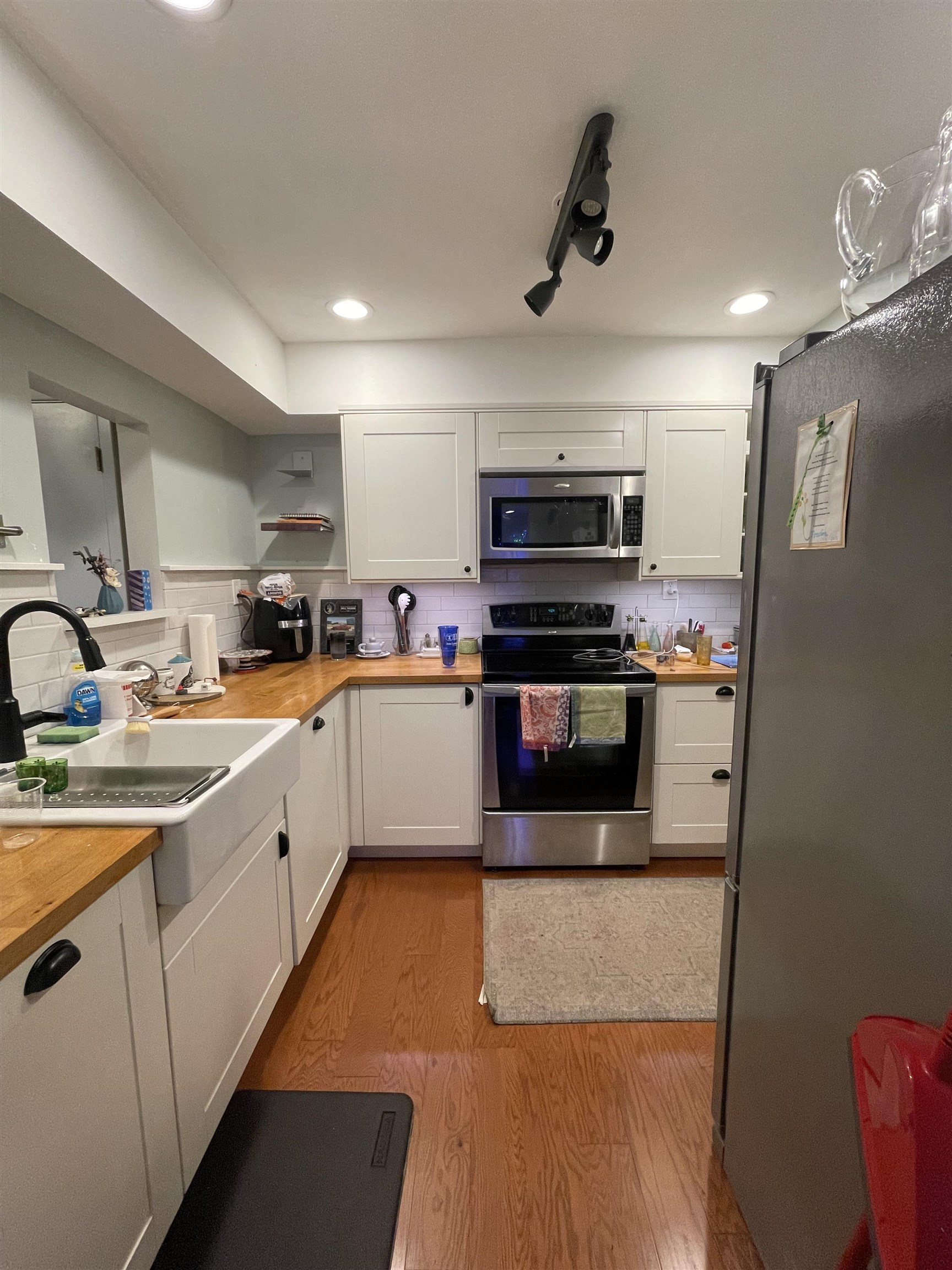 8469 Rothchild Road, Unit 33 Germantown, TN 38139 - Photo 8 of 25 Kitchen with white cabinets, decorative backsplash, light wood-type flooring, appliances with stainless steel finishes, and butcher block countertops