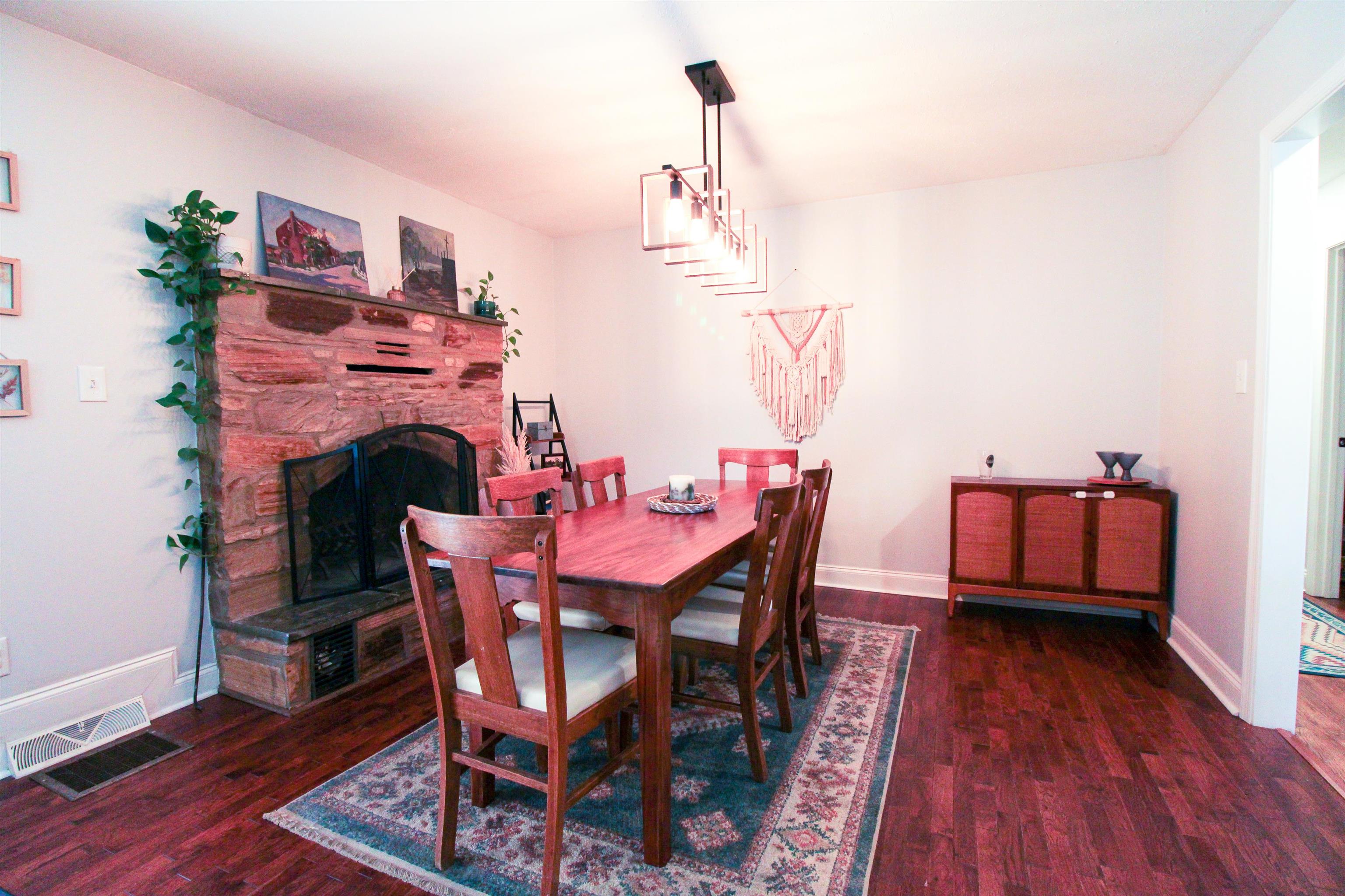169 Calf Mountain Road Waynesboro, VA 22980 - Photo 30 of 74 a dining room with furniture wooden floor a rug and a chandelier