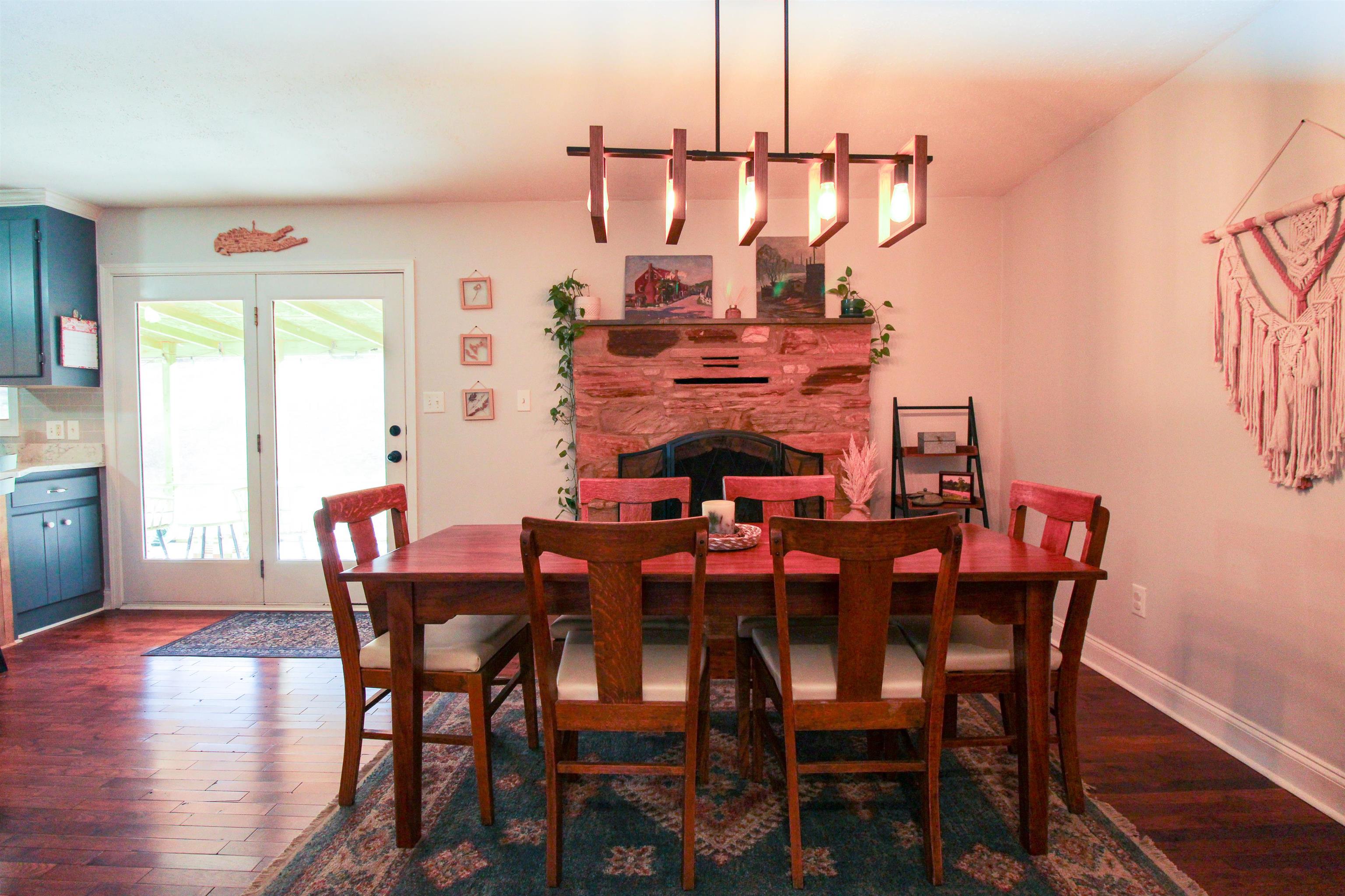 169 Calf Mountain Road Waynesboro, VA 22980 - Photo 31 of 74 a view of a dining room and livingroom with furniture wooden floor a chandelier