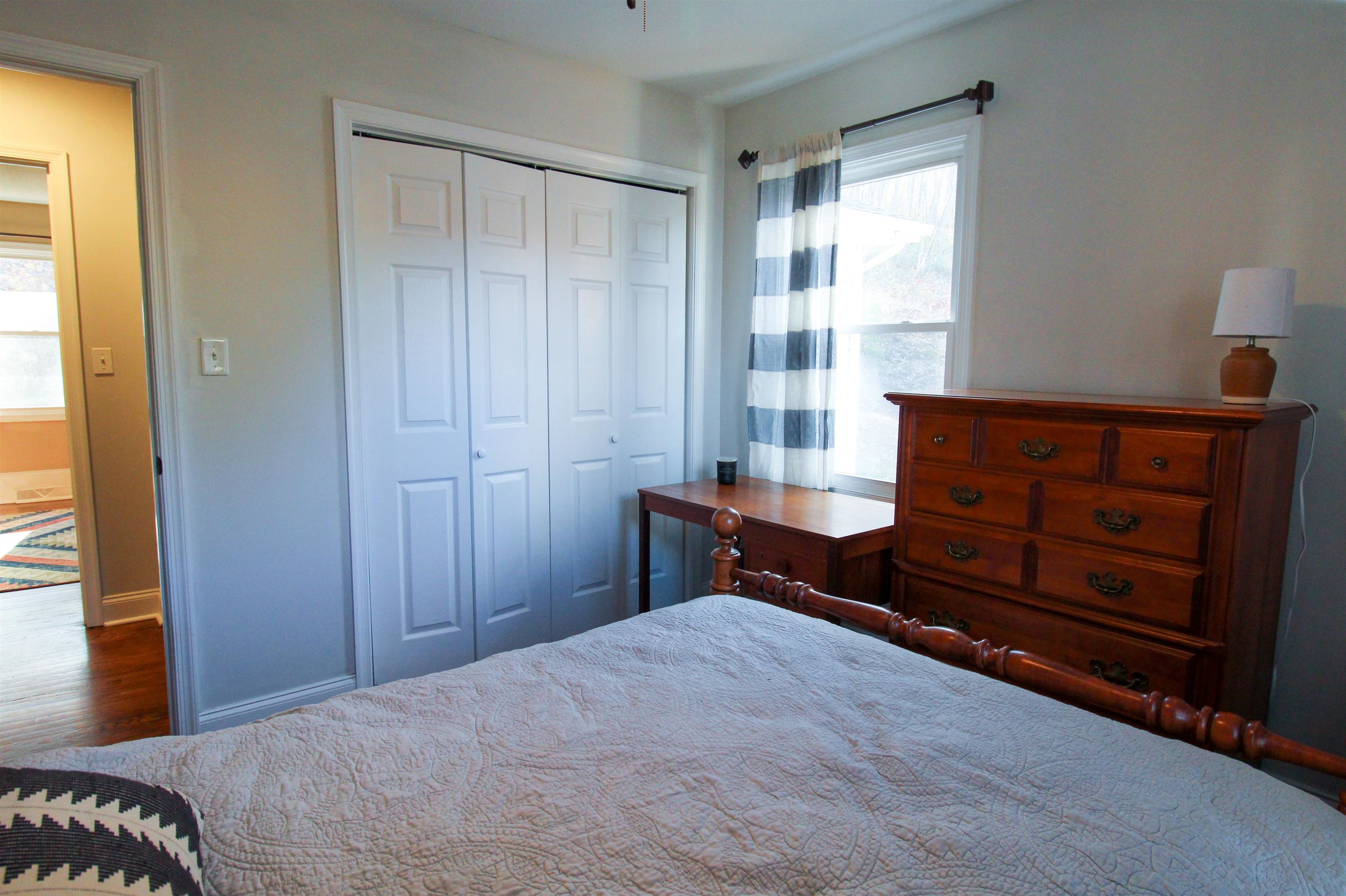 169 Calf Mountain Road Waynesboro, VA 22980 - Photo 57 of 74 a bedroom with a bed and a dresser next to a window