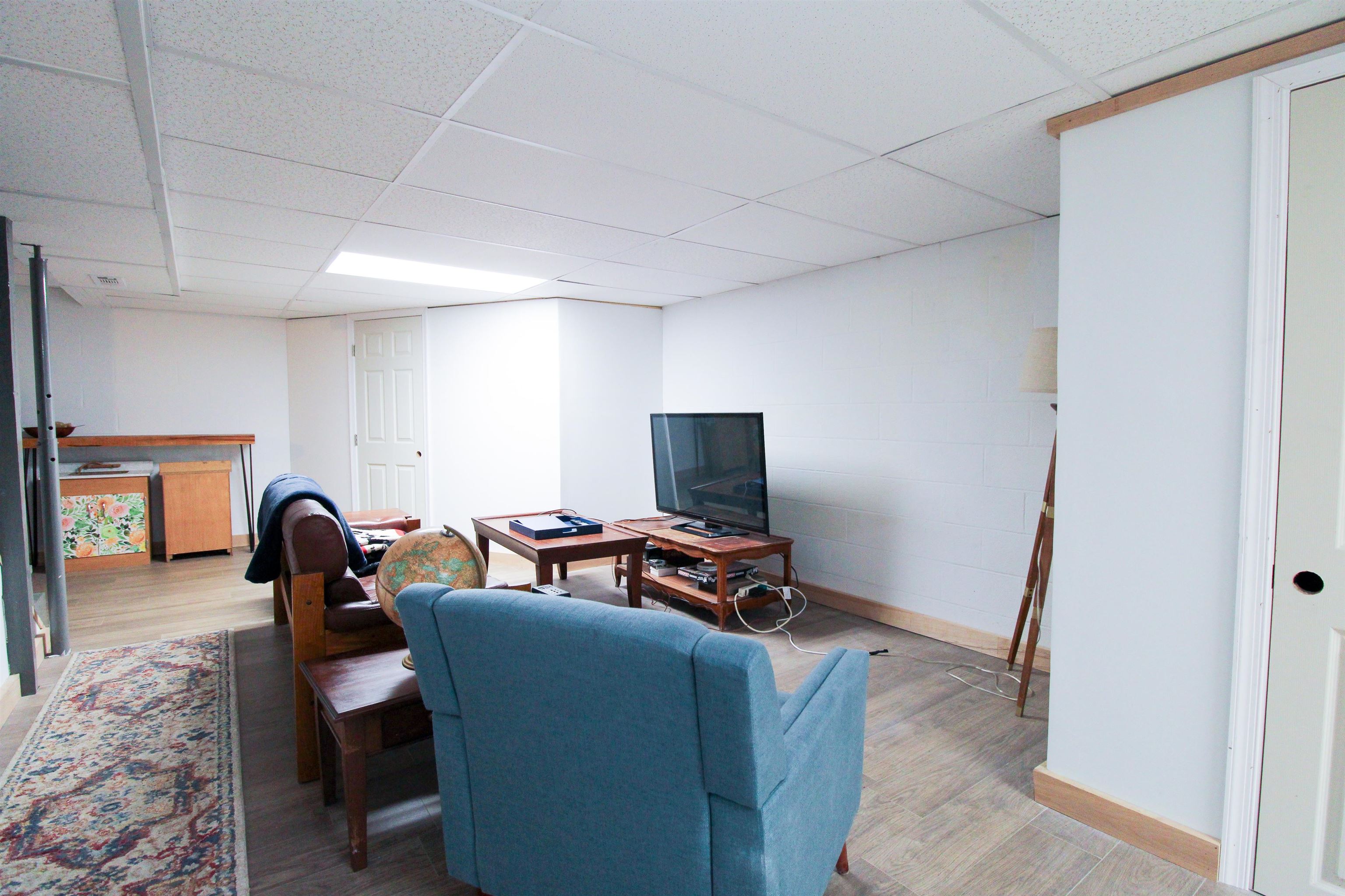 169 Calf Mountain Road Waynesboro, VA 22980 - Photo 62 of 74 a living room with furniture a flat screen tv and a refrigerator