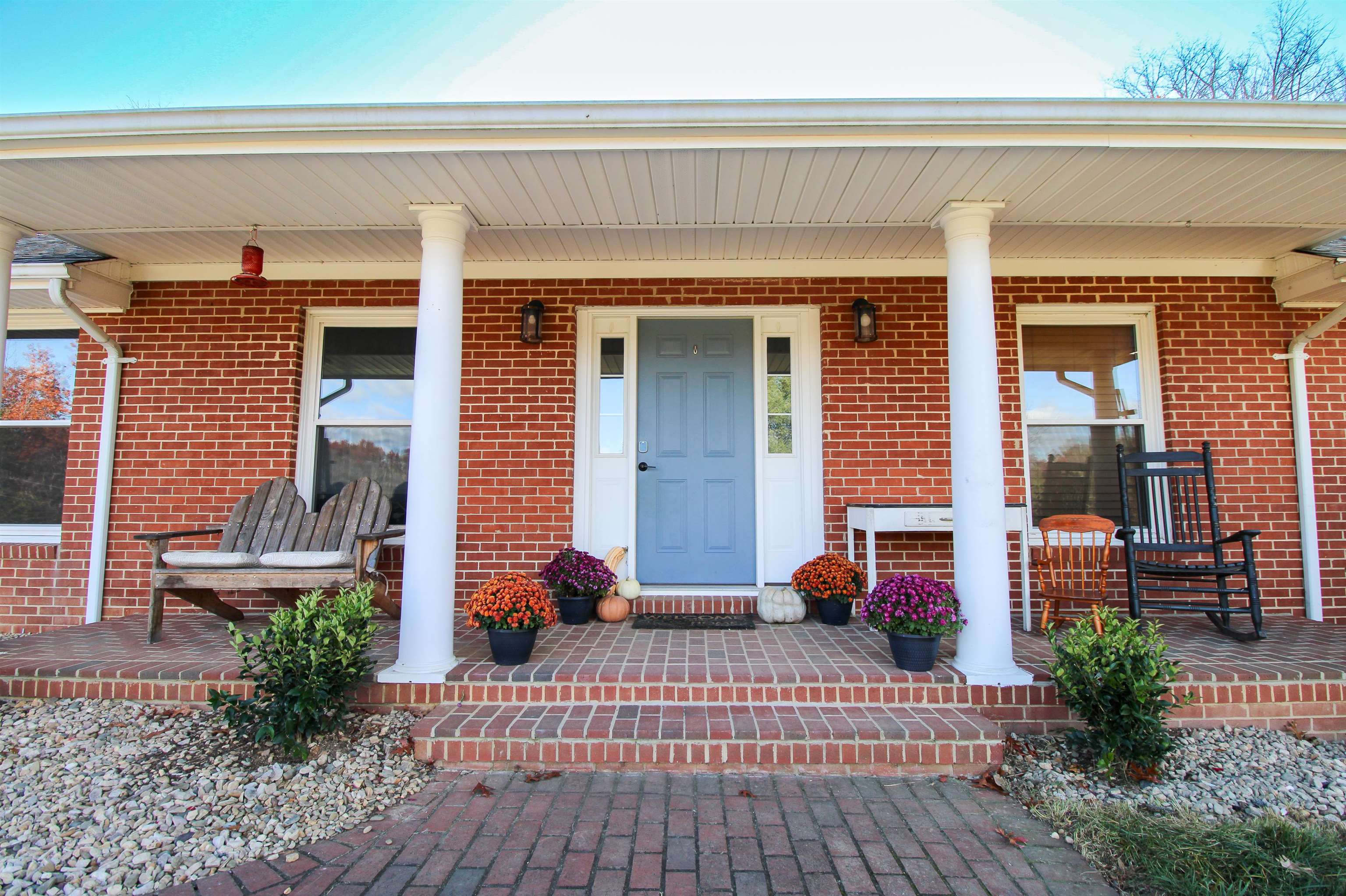 169 Calf Mountain Road Waynesboro, VA 22980 - Photo 10 of 74 a view of a patio with table and chairs potted plants and floor to ceiling window