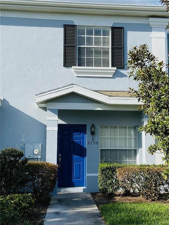 9358 Flowering Cottonwood Road, Unit 15 Orlando, FL 32832 - Photo 1 of 1 a front view of a house with a garden