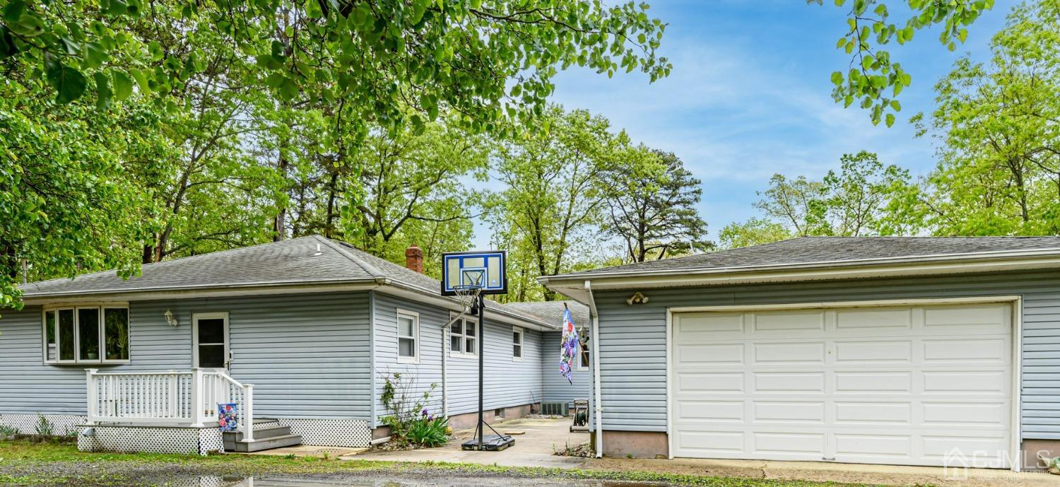 439 Cassville Road Jackson, NJ 08527 - Photo 1 of 45 a front view of a house with garden