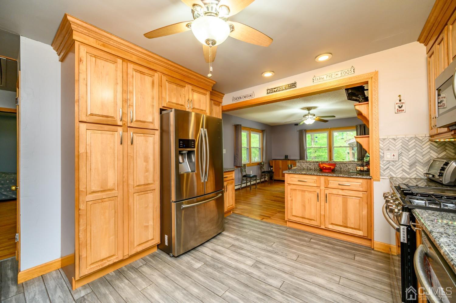 439 Cassville Road Jackson, NJ 08527 - Photo 17 of 45 a kitchen with stainless steel appliances granite countertop a refrigerator and a stove top oven