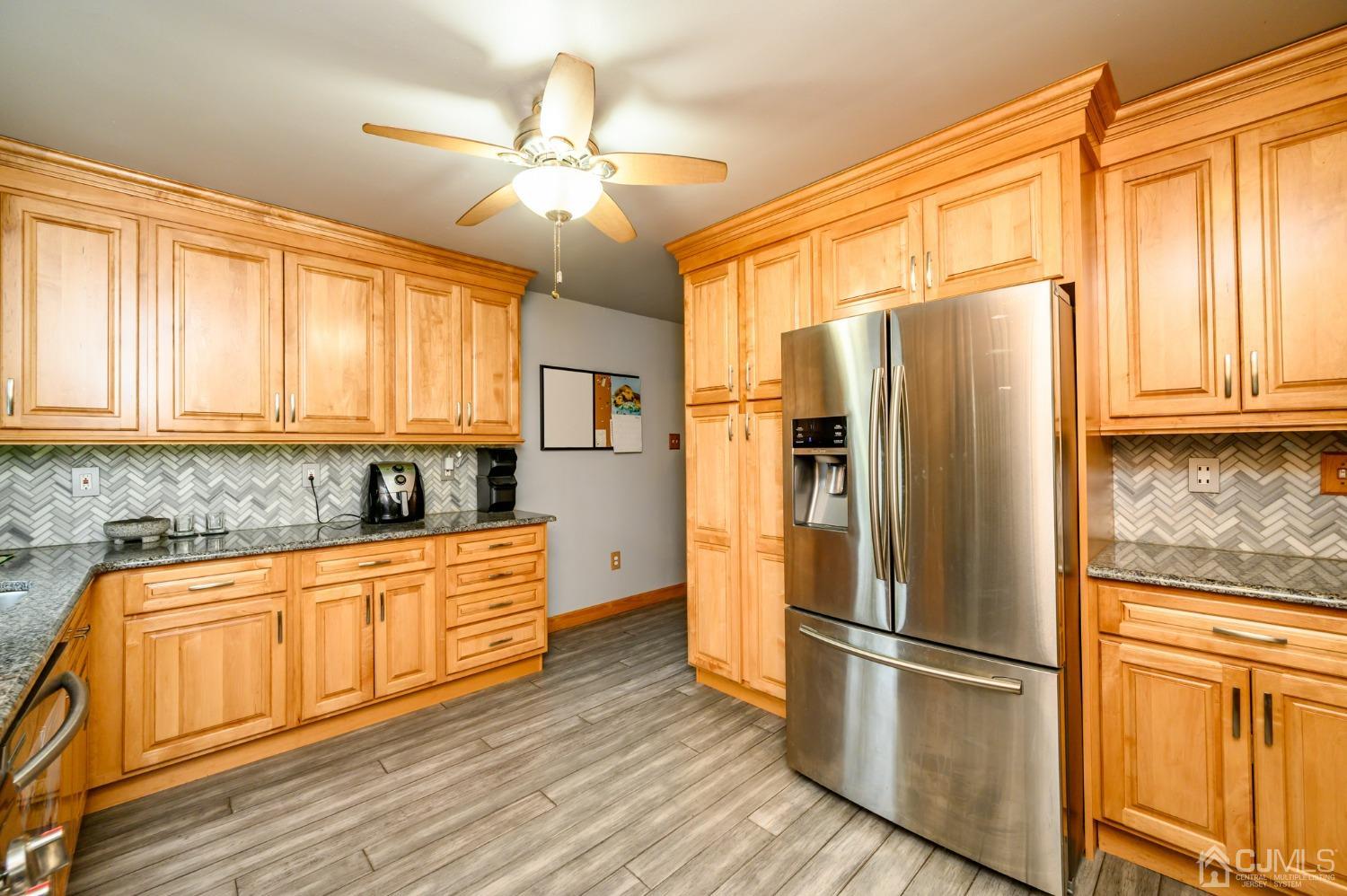 439 Cassville Road Jackson, NJ 08527 - Photo 18 of 45 a kitchen with stainless steel appliances granite countertop a refrigerator a sink and white cabinets