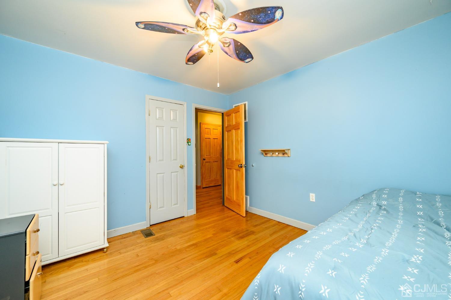 439 Cassville Road Jackson, NJ 08527 - Photo 26 of 45 a bedroom with a bed and a chandelier