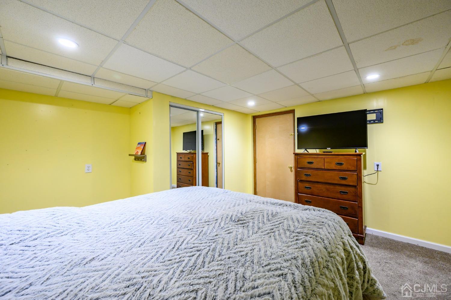 439 Cassville Road Jackson, NJ 08527 - Photo 31 of 45 a bedroom with a bed and a flat screen tv