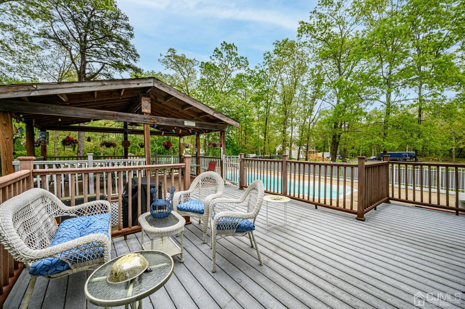 439 Cassville Road Jackson, NJ 08527 - Photo 35 of 45 a patio with wooden floor a yard a table and chairs