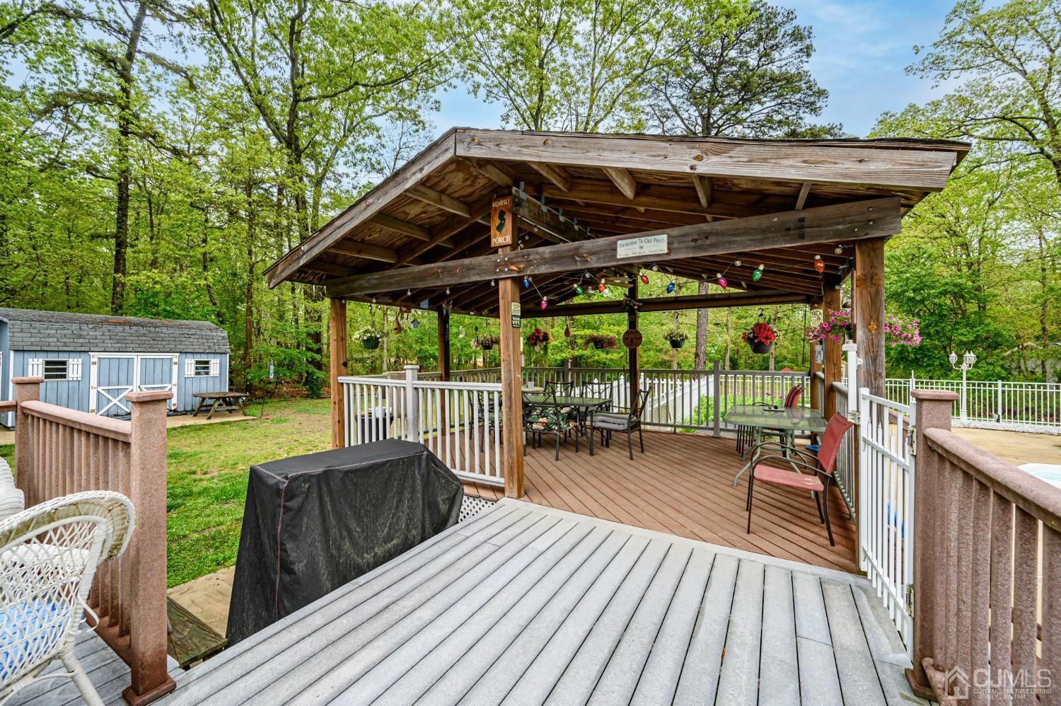439 Cassville Road Jackson, NJ 08527 - Photo 36 of 45 a view of a deck with wooden floor a yard a table and chairs