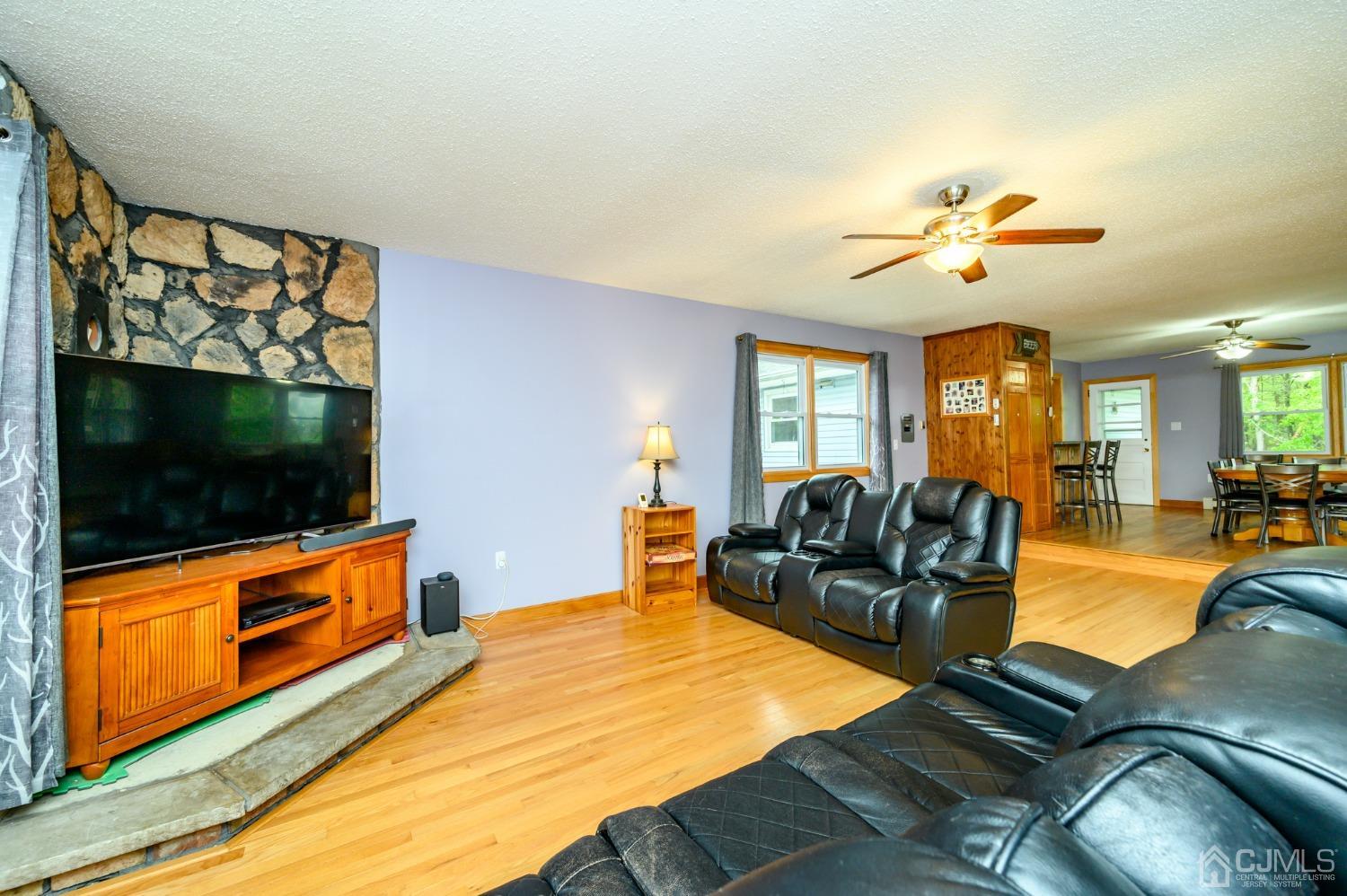 439 Cassville Road Jackson, NJ 08527 - Photo 10 of 45 a living room with furniture and a flat screen tv