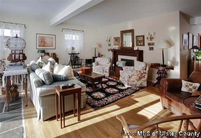 895 Buck Road Stone Ridge, NY 12484 - Photo 12 of 22 a living room with furniture and a fireplace
