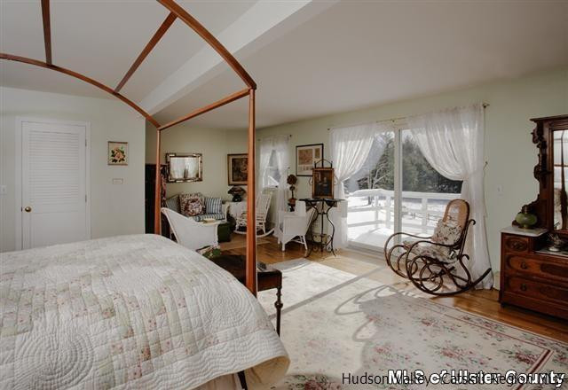 895 Buck Road Stone Ridge, NY 12484 - Photo 15 of 22 a bed room with furniture a window and gym equipment