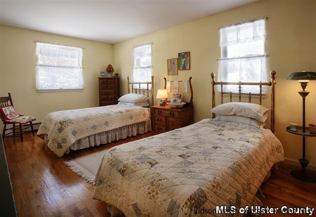 895 Buck Road Stone Ridge, NY 12484 - Photo 17 of 22 a bedroom with two beds and a table