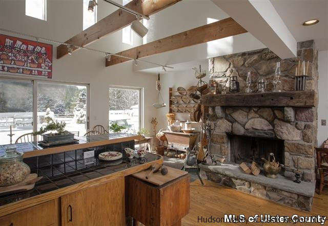 895 Buck Road Stone Ridge, NY 12484 - Photo 7 of 22 a kitchen with a stove and a fireplace