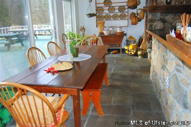 895 Buck Road Stone Ridge, NY 12484 - Photo 8 of 22 a view of a dining room with furniture and a potted plant