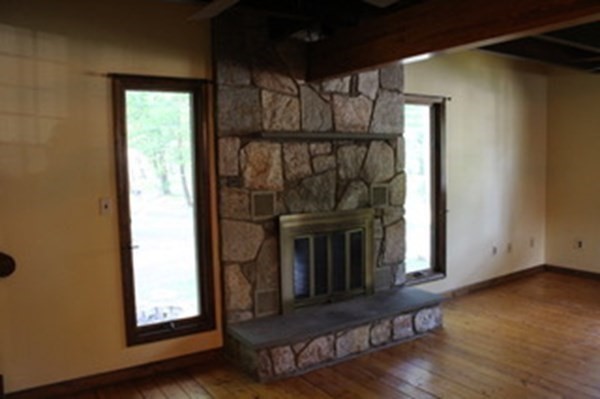 30 Birchmeadow Road Amesbury, MA 01913 - Photo 10 of 26 a view of a livingroom with wooden floor and a fireplace
