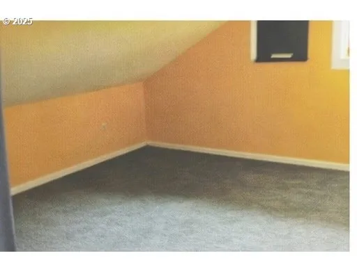 a view of an empty room and basketball court