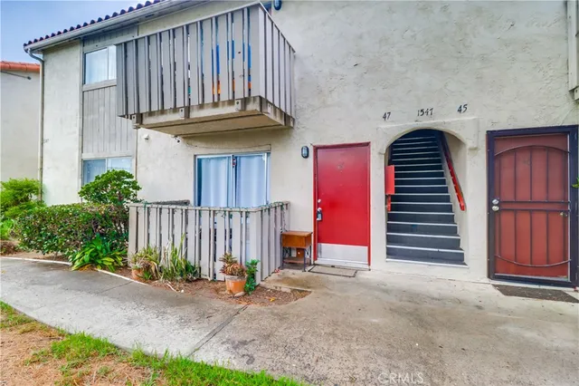 a view of a house with wooden fence