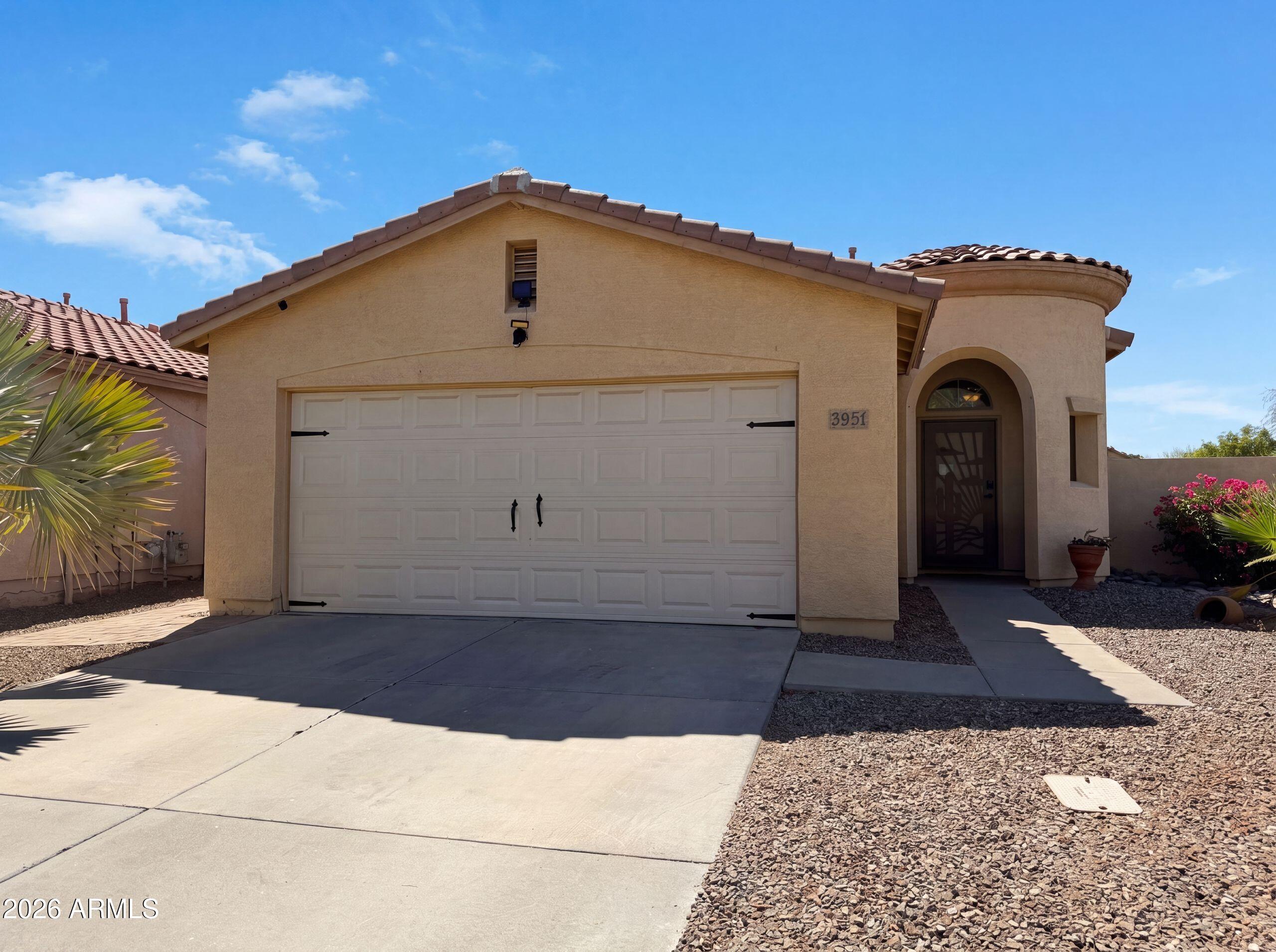 3951 East Timberline Road Gilbert, AZ 85297 - Photo 26 of 28 a view of a grey house with a yard