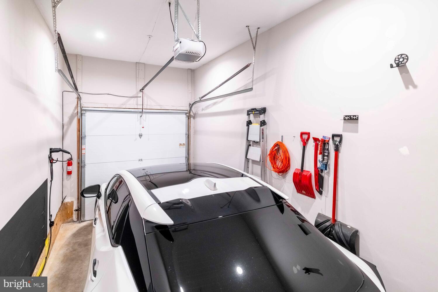 1224 North 26th Street, Unit F1 Philadelphia, PA 19121 - Photo 24 of 25 Modern garage with sleek vehicle and tools.