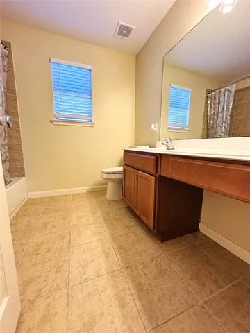 a bathroom with a toilet a sink and a mirror