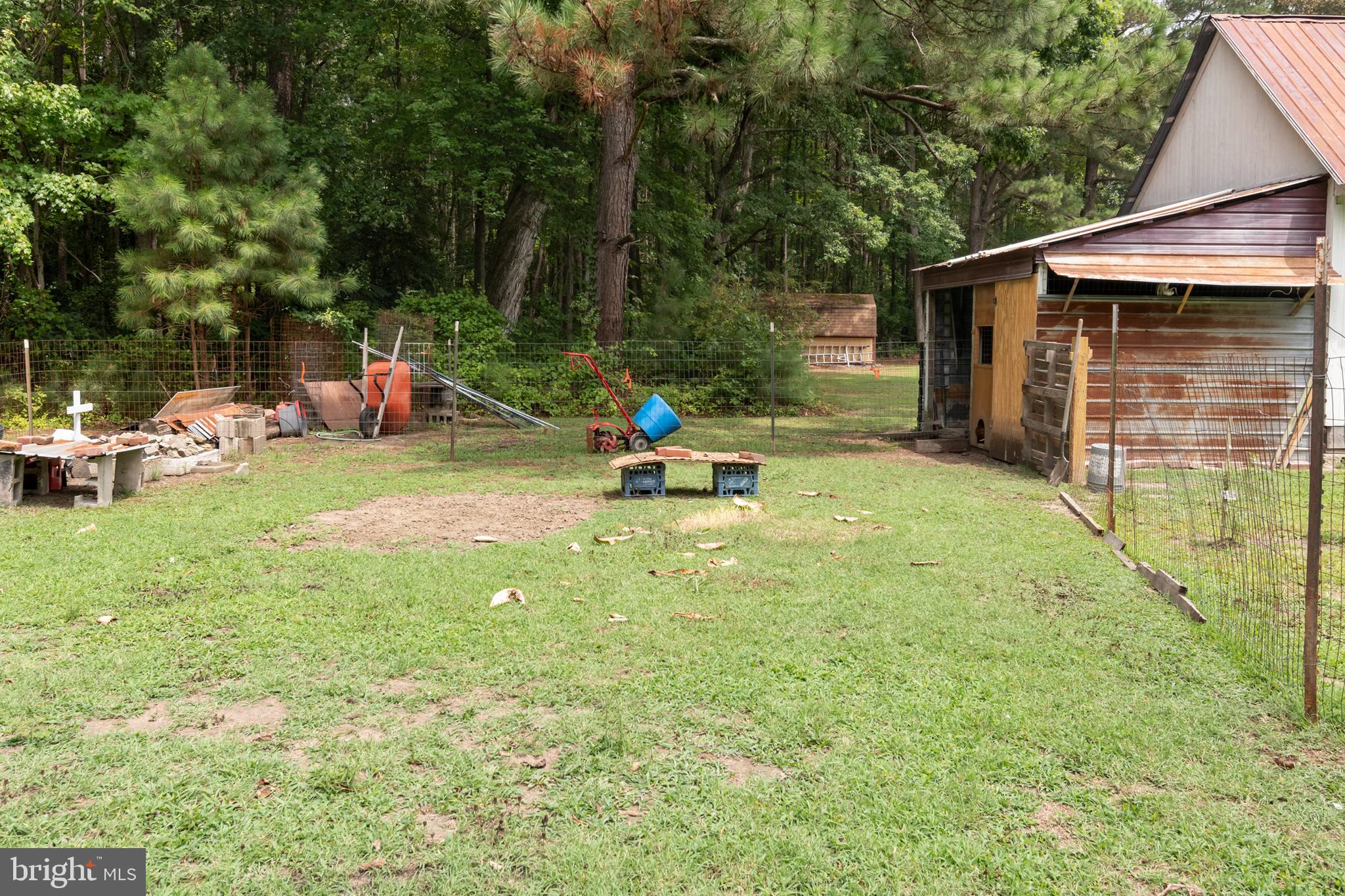 5614 Casson Neck Cambridge, MD 21613 - Photo 14 of 38 a backyard of a house with table and chairs