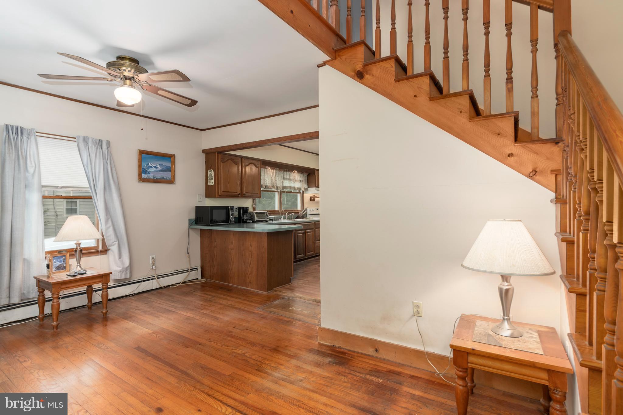 5614 Casson Neck Cambridge, MD 21613 - Photo 15 of 38 a view of a livingroom with furniture a dinning room and stairs