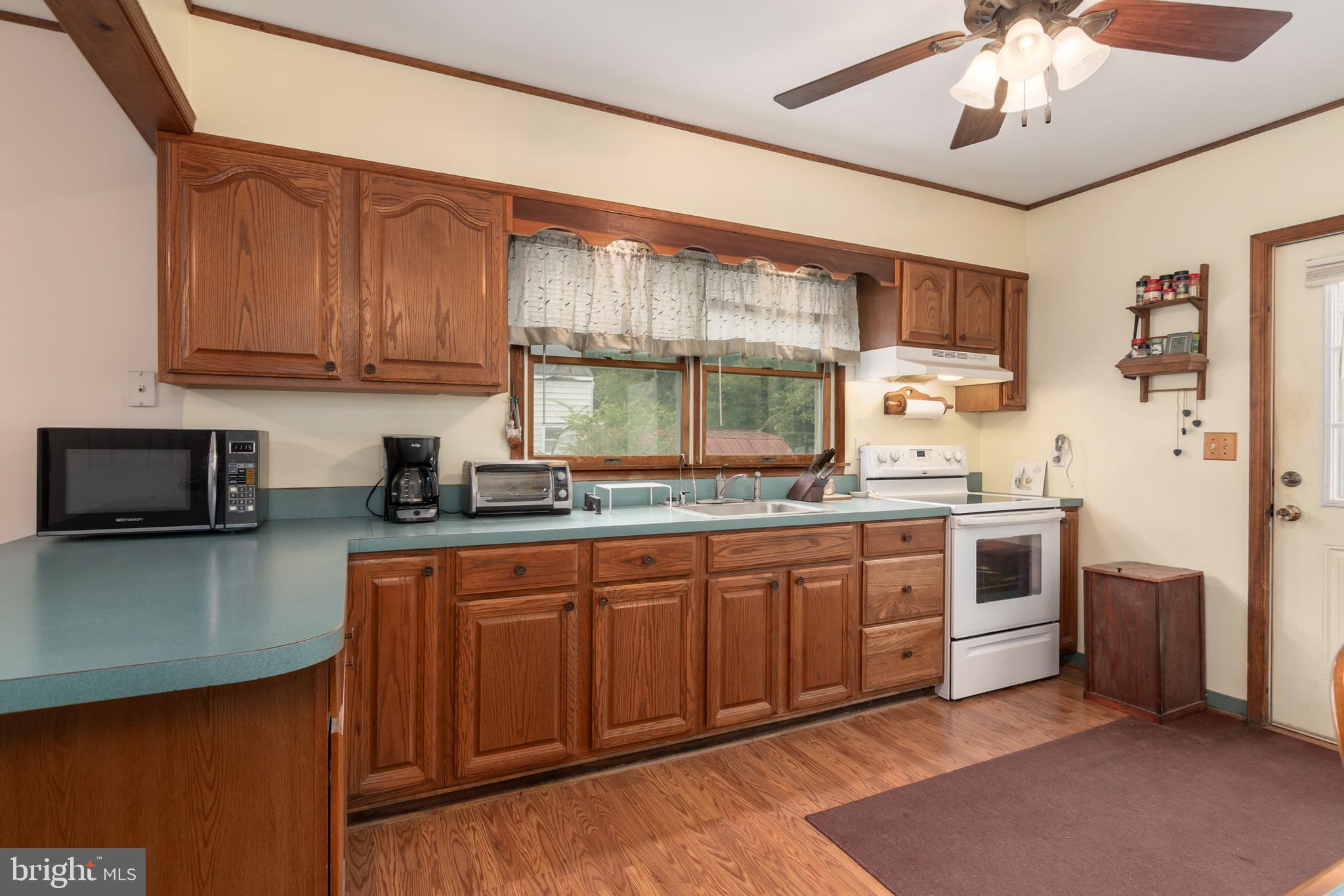 5614 Casson Neck Cambridge, MD 21613 - Photo 20 of 38 a kitchen with stainless steel appliances granite countertop a stove sink and cabinets