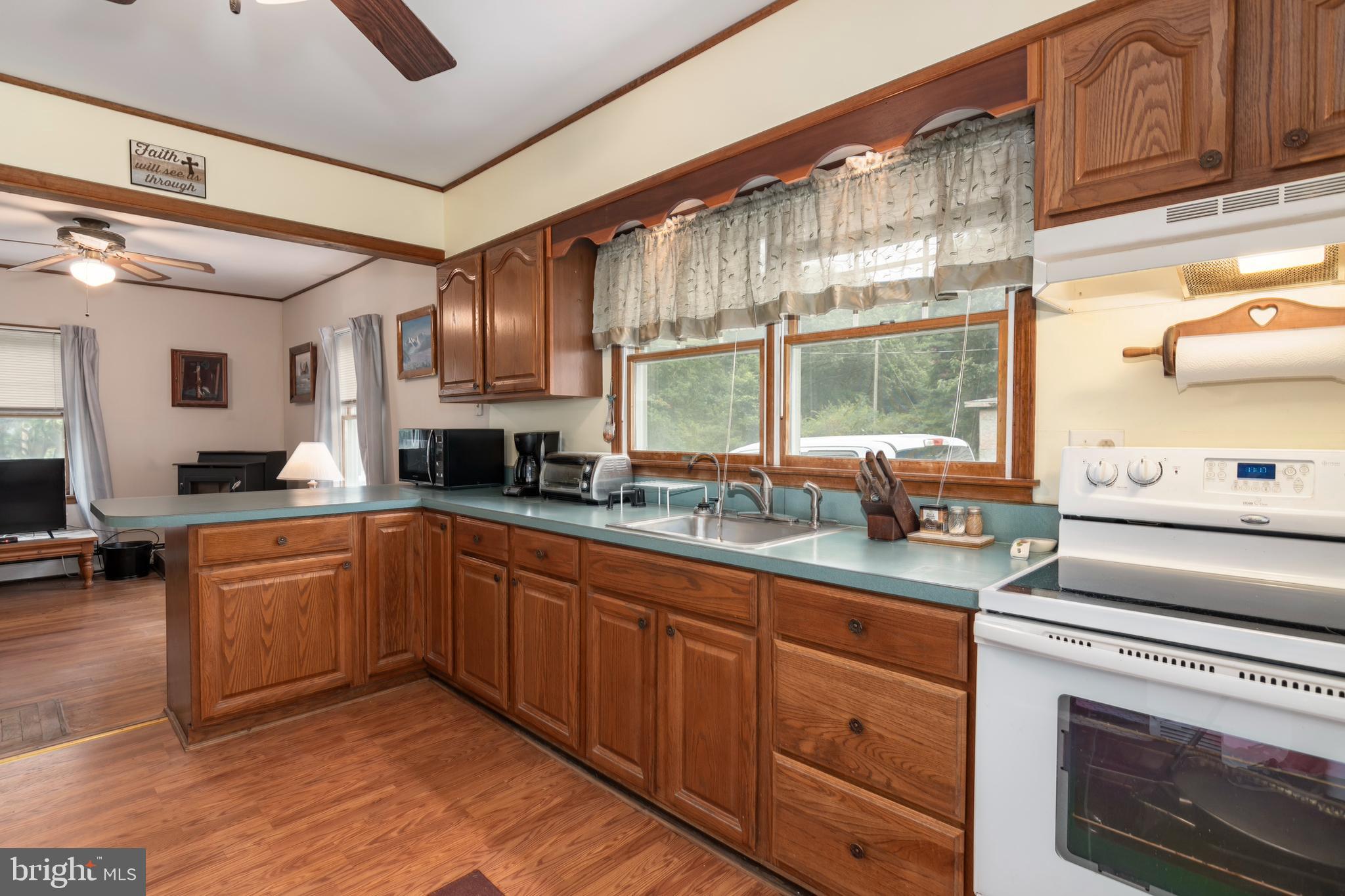 5614 Casson Neck Cambridge, MD 21613 - Photo 21 of 38 a kitchen with granite countertop stainless steel appliances a sink and cabinets