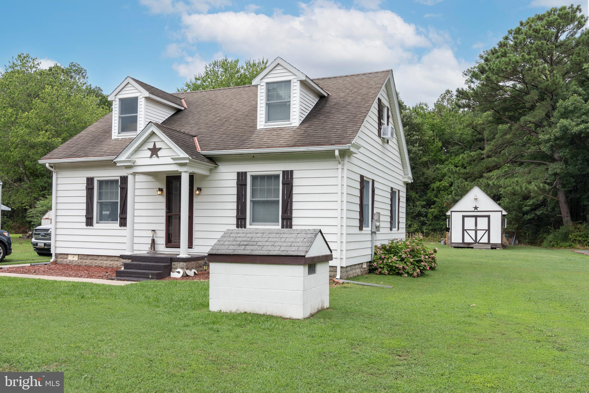 5614 Casson Neck Cambridge, MD 21613 - Photo 3 of 38 a front view of a house with a garden and plants