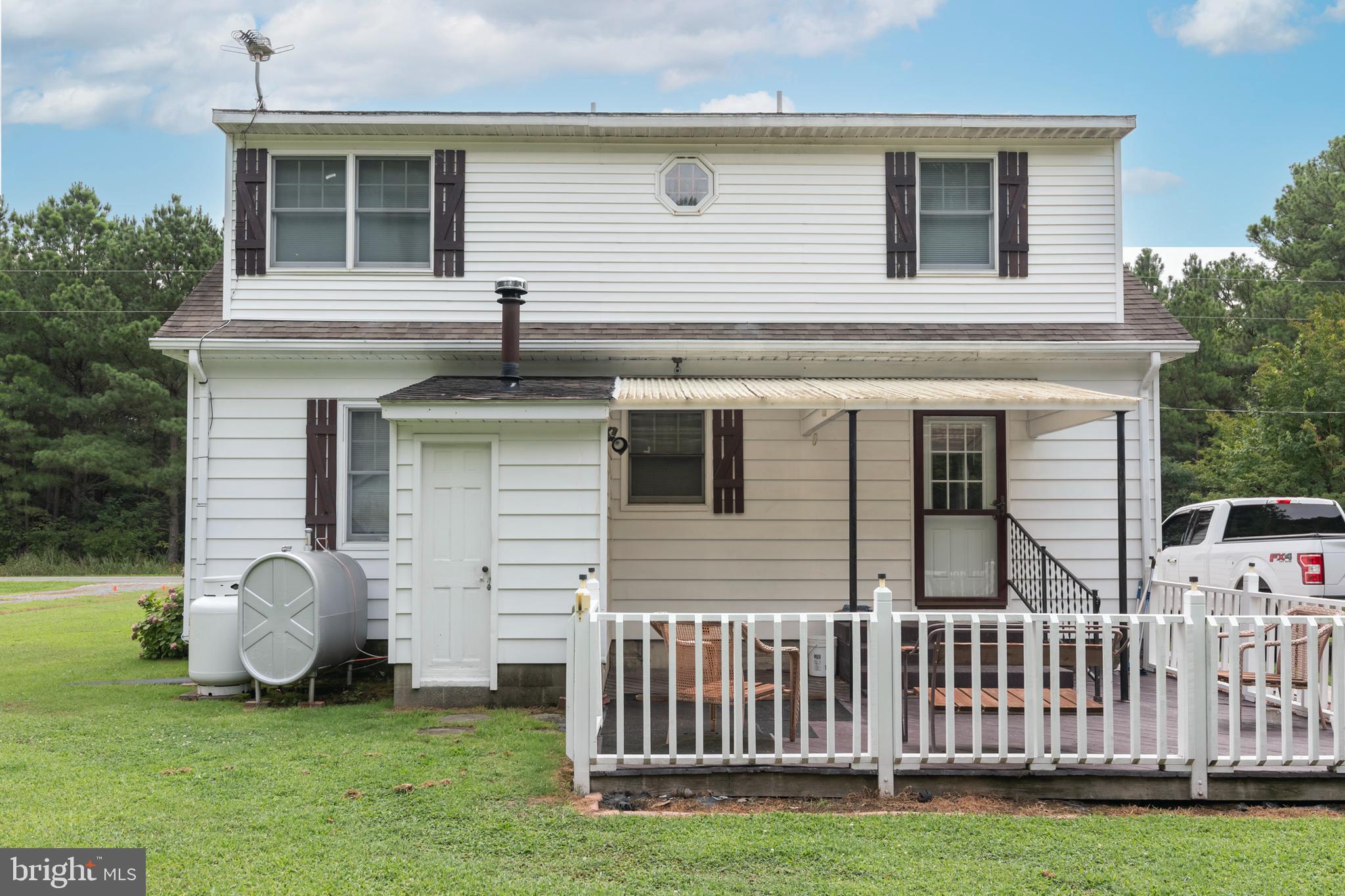 5614 Casson Neck Cambridge, MD 21613 - Photo 6 of 38 a front view of a house with a yard
