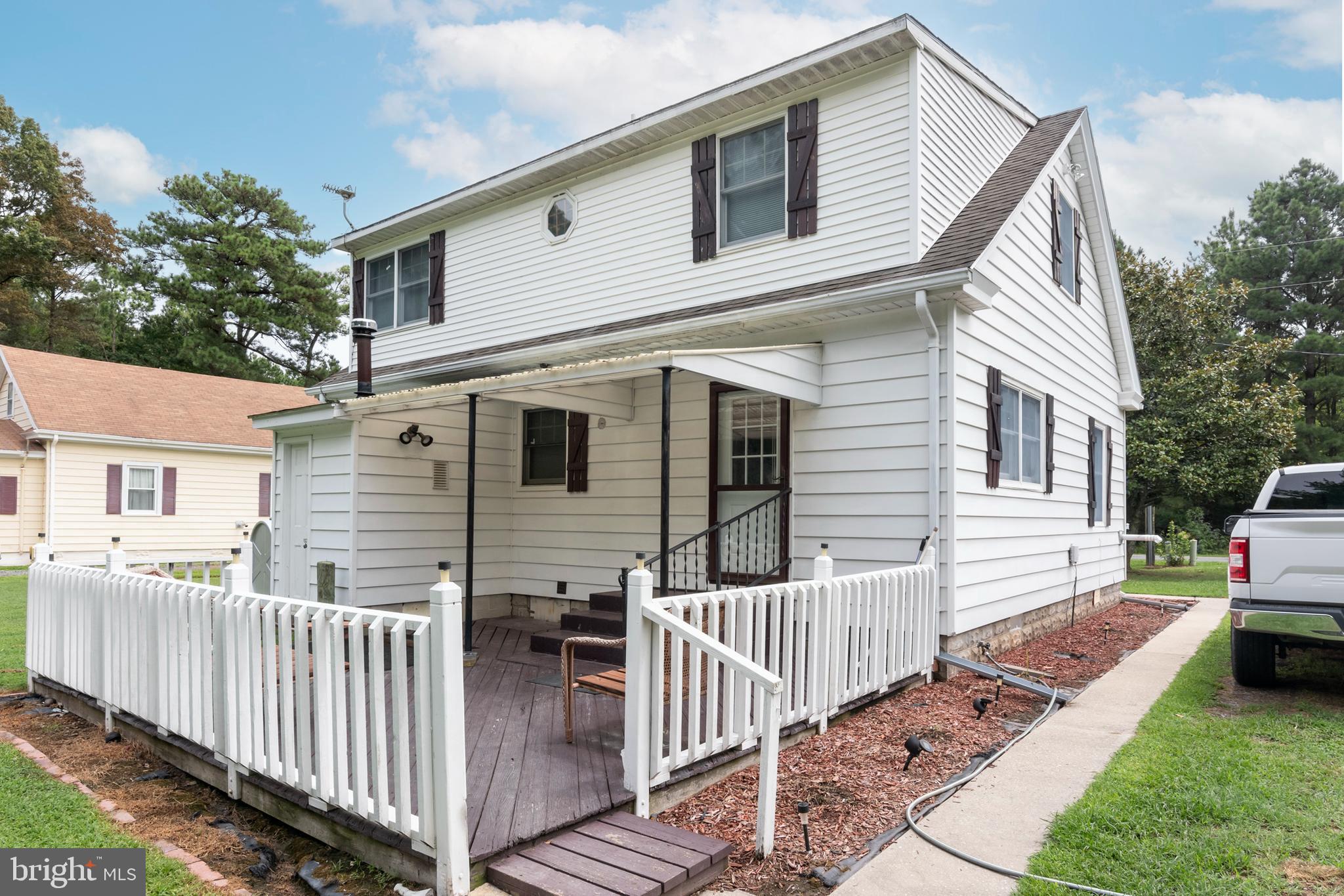5614 Casson Neck Cambridge, MD 21613 - Photo 8 of 38 a view of a white house with wooden fence