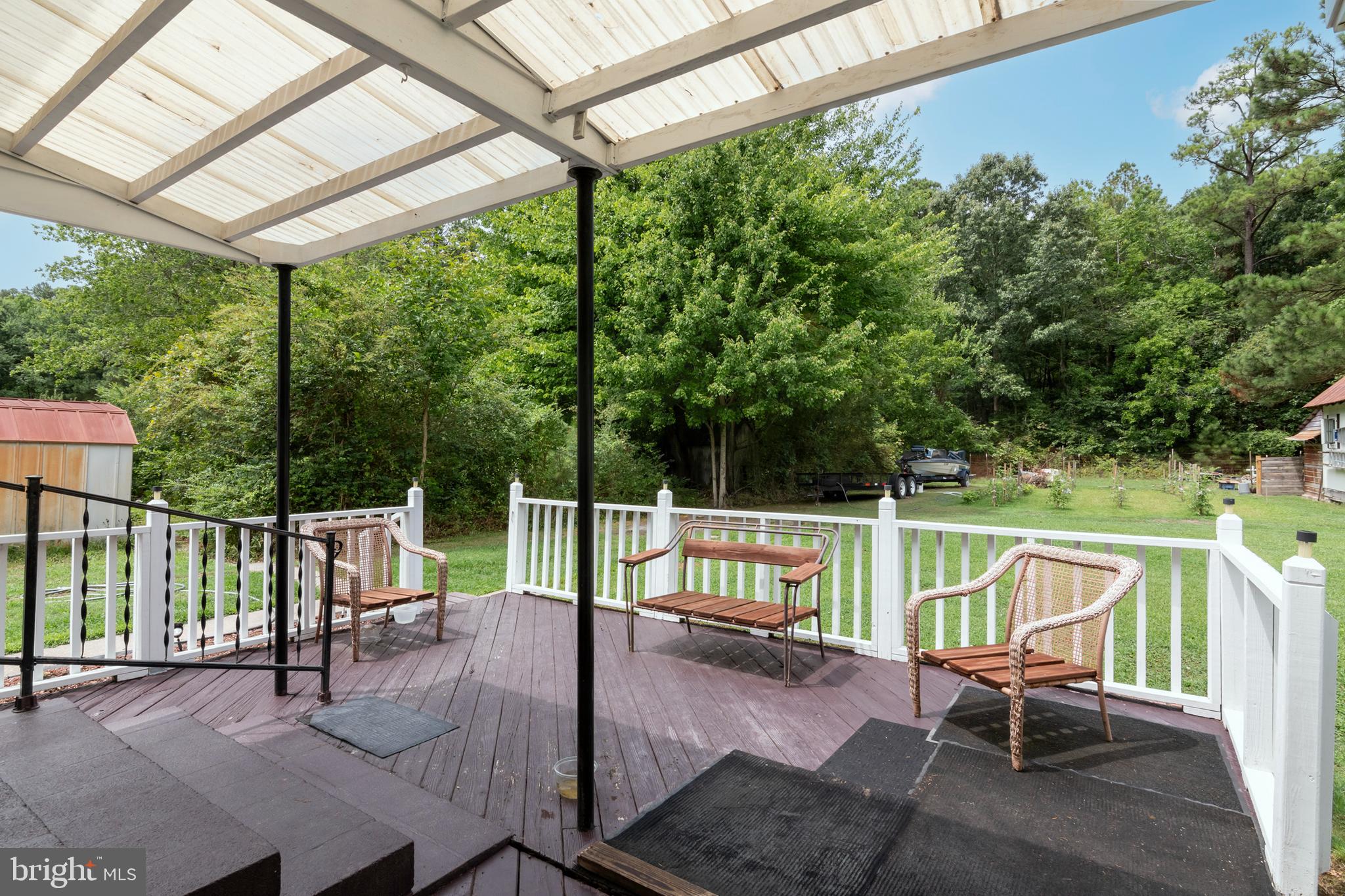 5614 Casson Neck Cambridge, MD 21613 - Photo 10 of 38 a view of a patio with a table chairs and a backyard